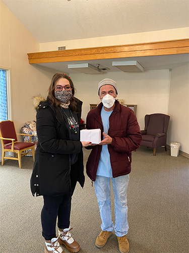 Blog - Olivia Keltz at Shippenville Healthcare and Rehab Handing a Card to a Woman